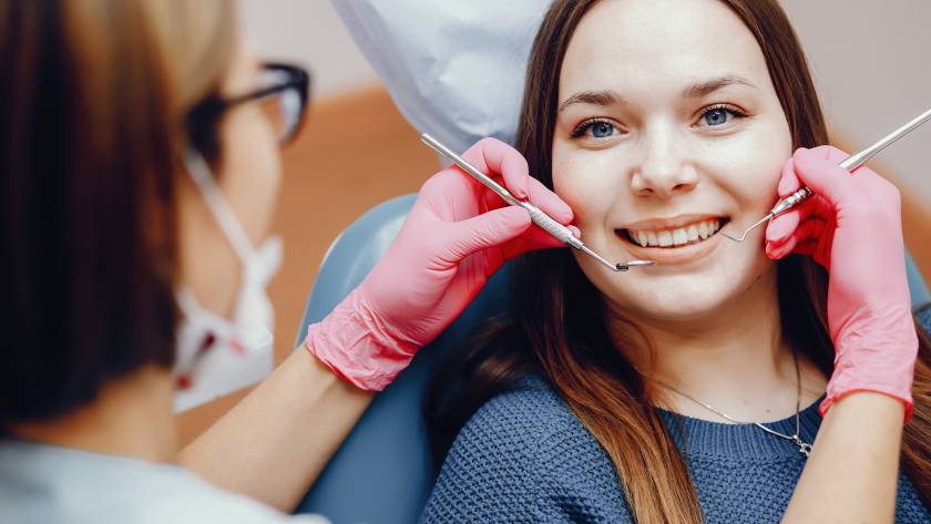 Patient undergoing front tooth cavity treatment with tooth-colored composite filling at dental clinic