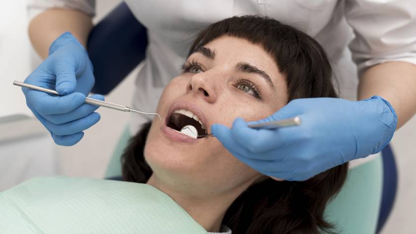Dentist examining a damaged tooth during dental evaluation for root canal treatment and infection assessment