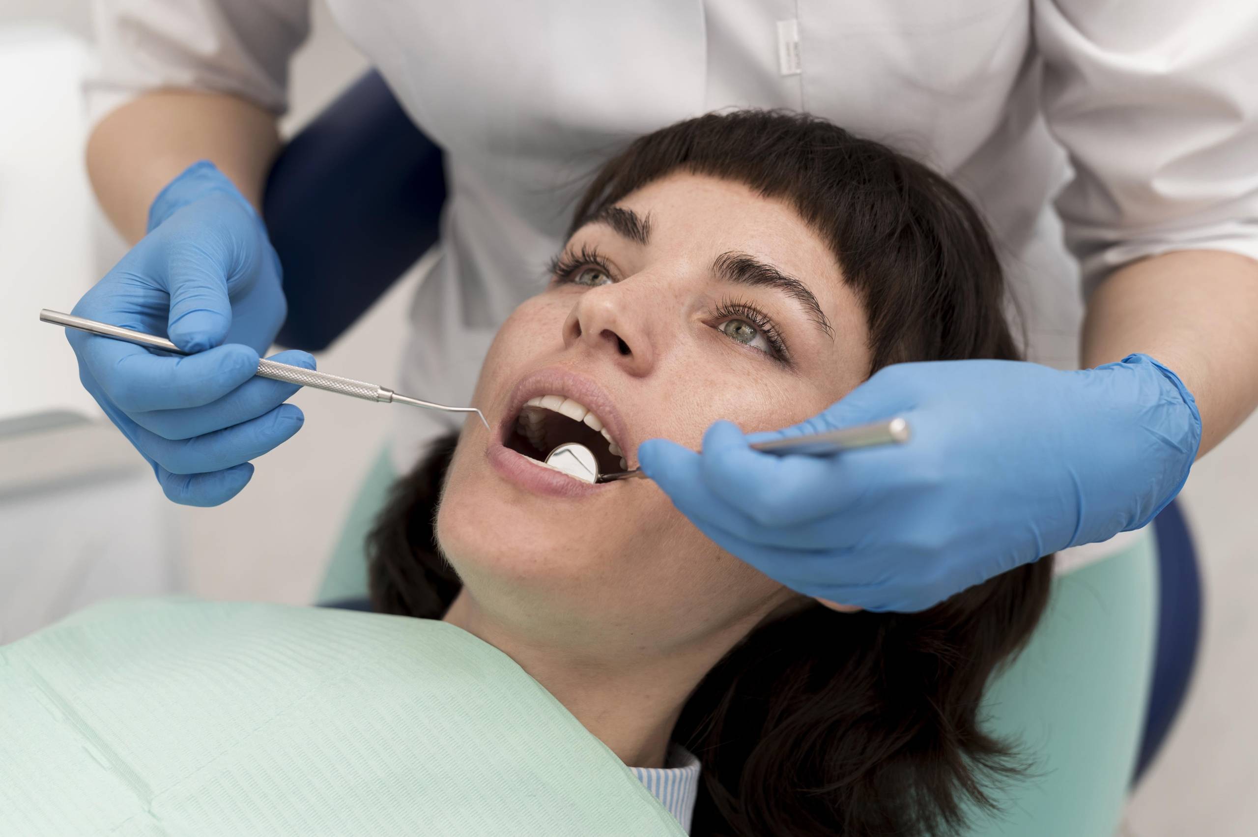 Dentist examining a damaged tooth during dental evaluation for root canal treatment and infection assessment