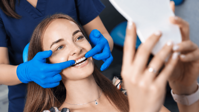 Dentist examining a patient's teeth during a cosmetic dental consultation