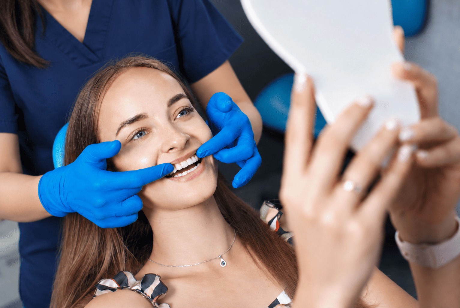 Dentist examining a patient's teeth during a cosmetic dental consultation